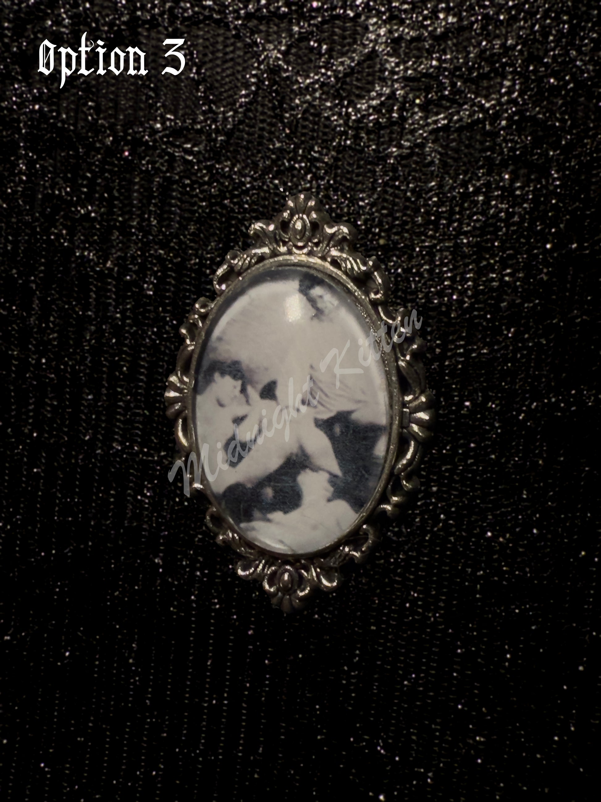 A silver ring with the decorative setting of a framed photograph on a hand against a textured black background. Option 3 contains a Victorian era pornographic image of a ménage à trois.